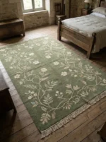 Sage green hand knotted wool rug with floral vine design handcrafted in Bhadohi India
