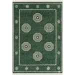Hand-knotted green geometric wool rug on a minimalist light oak floor