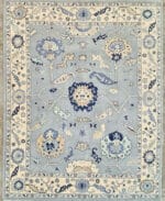 blue Oushak rug in soft ivory with traditional floral design